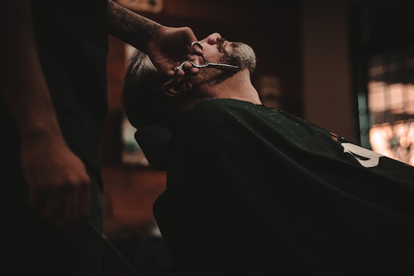Barbier réalisant un rasage